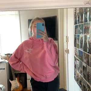 Rosa hoodie, storlek L - Rosa hoodie med luva och vitt tryck, storlek L från Grinatricot. Pris: 120kr inklusive frakt 