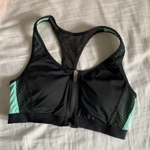 Sport-bh med dragkedja - Sport-bh med bra support. Dragkedjan går att dra hela vägen vilket gör den lätt att ta på. Smickrande brottarrygg