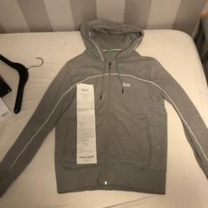 Hugo boss hoodie - Tröjan är lite sönder över fickan åt höger och inuti vid dragkedjan. Inuti är det inte synligt och märks inte när man har på sig den men vid fickan synd det. Den är inköpt i en Hugo boss affär för 1.249 och kvitto finns