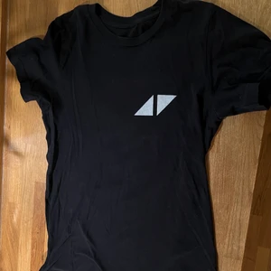 T-shirt med Avicii tryck - Svart T-shirt med Avicii tryck i silver. Storlek S. Fint skick. Vid frågor, hör av dig!