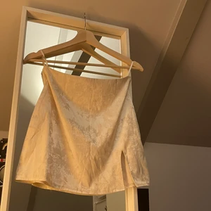 Mini kjol  - Vit/ off white mini kjol i storlek S med ett litet slits. Blommigt broderat mönster. Kan mötas upp i Malmö/ Lund området annars står köparen för frakten.