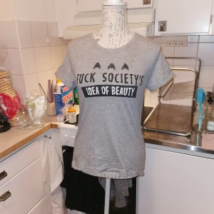 Cool t-shirt i Medium - Cool t-shirt från Cropp i storlek M med texten "fuck society's idea of beauty" på bröstet. 