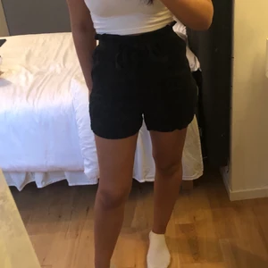 Paperbag shorts - Svarta shorts i tyg från H&M i storlek 36.