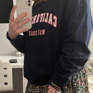 Mörkblå sweatshirt med tryck storlek: S - Mörkblå sweatshirt med rött och vitt tryck (storlek: S.) Köptes från Shein för ca 2 månader sen och har inte kommit till någon användning. 