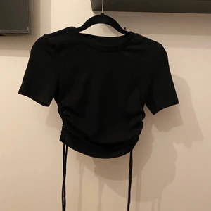 topp med snörning  - snygg topp med snörning på sidorna! Aldrig använd endast testad. 90kr+frakt