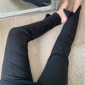 Svarta byxor med slits i vanligt tyg med en söm i bitten av benet. Från nelly ursprungligen i storlek M. Finns en skrap skada på knät vilket inte syns på bilderna men självklart kan jag skicka bild på den också.