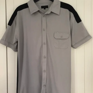 Grå skjorta  - Har skjorta med svarta detaljer. Det är en XL men känns mer som en L