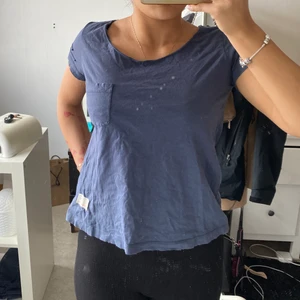 Odd Molly t-shirt - Marinblå T-shirt från märket Odd Molly. Strl 1 eller S. Ficka på framsidan, detaljer vid ärmarna och en slits med rosett där bak. Köpt för ca 4 år sen, använd i början men inte använd på kanske 2 år. Fint skick. 