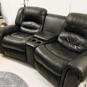 Bio soffa / fåtölj  - Denna sköna bio soffa är till salu. Väldigt skön två sitsig med en bord emellan sig, under bordet finns också en låda där man kan lägga tex snacks. Två kopphållare finns också samt utfällbara ben stöd.