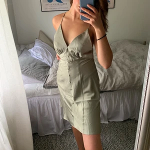 Klänning i satin - Helt ny olivgrön klänning i satin från asos. Aldrig använd, tänkte returnera då jag inte känner mig helt bekväm i just klänning, men tiden hade gått ut så därför säljer jag den här istället. Superfin!