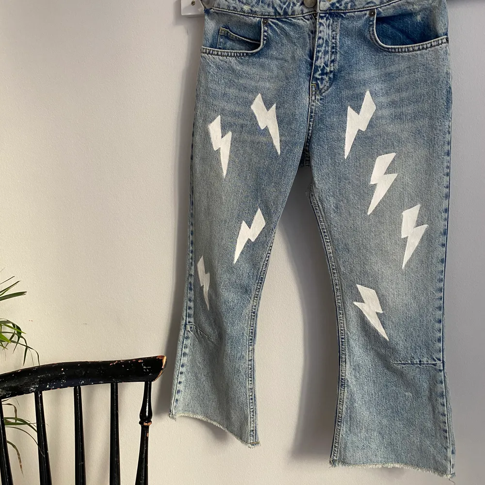 Handmålade jeans originellt från ASOS målade med vita blixtar i en cropped flare modell. Jeansen är i bra skick och kvaliten är hyfsat tjock. Storlek: 26/28.                 Buda nere i kommentarerna! Högsta bud: . Jeans & Byxor.