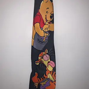 Cute winne the pooh tie, a little textured at the bottom barley noticable. 