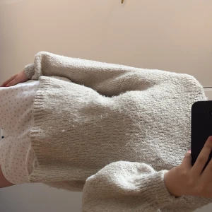 Beige stickad tröja - Mysig beige stickad tröja med lång ärm och avslappnad passform. Tröjan har ribbade muddar vid ärmslut och nederkant, perfekt för lager-på-lager-stil. Enkel och stilren design som passar till mycket.