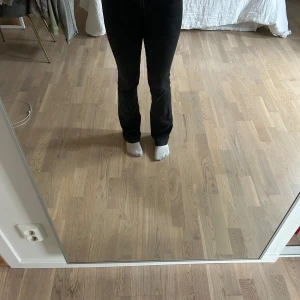 Svarta bootcut jeans från Zara - Säljer ett par svarta bootcut jeans från Zara. Jeansen har klassisk femficksdesign, normal passform upptill och utsvängda ben. Stängs med dragkedja och knapp. Perfekta till många olika outfits!