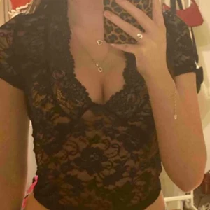 Svart spetsblus - (LÅNAD BILD) Säljer en svart spetsblus med korta ärmar och v-ringning. Använd endast 1 gång 