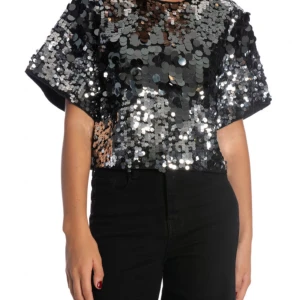 Silver paljettopp från Selected Femme - Säljer en glittrig silverfärgad paljettopp från Selected Femme. Toppen har korta ärmar och en lös passform, perfekt för en festlig kväll. Den är täckt av stora paljetter som ger en fantastisk glans och glamour. Den är helt oanvänd och prislappen är kvar