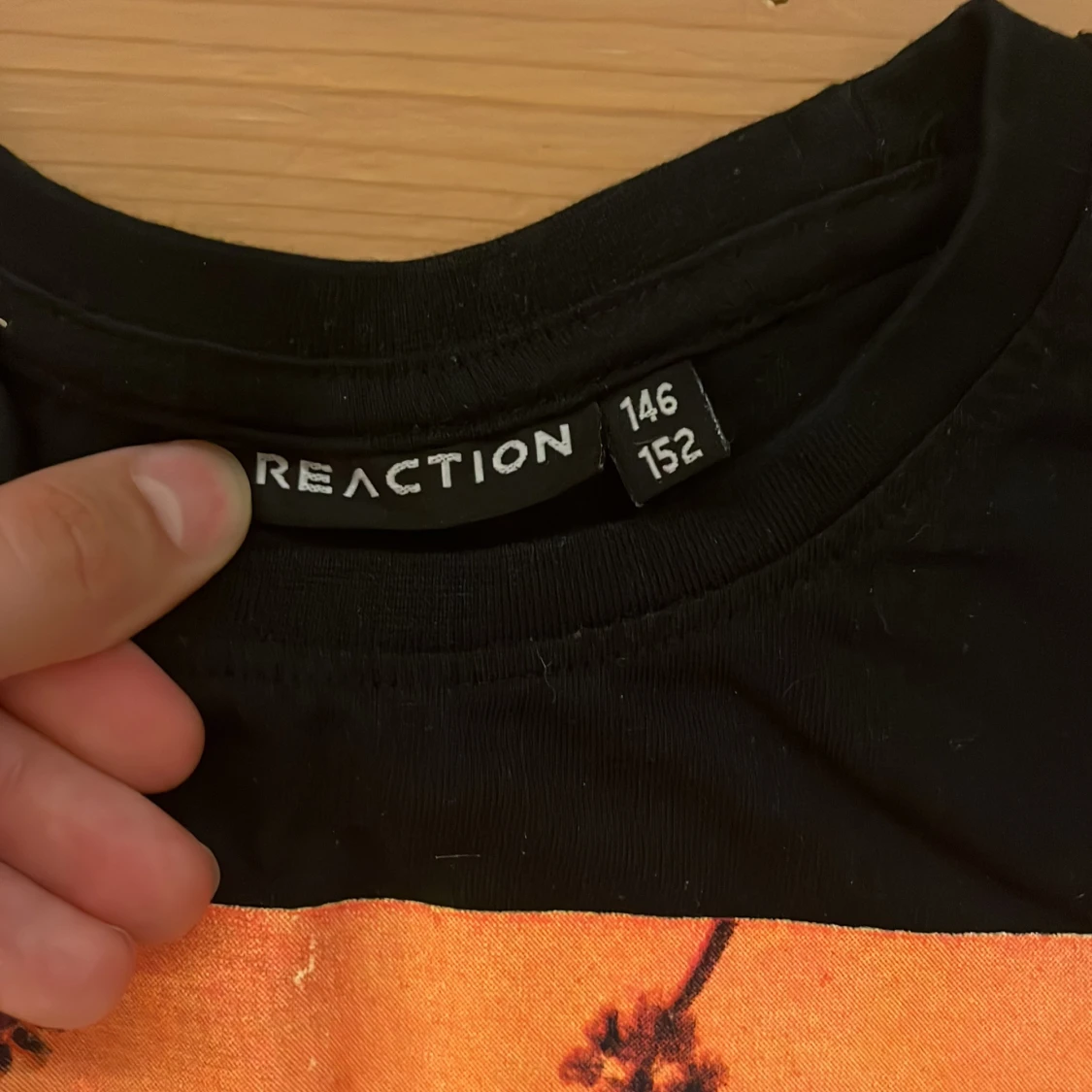 Svart t-shirt med orange print REACTION - 1
