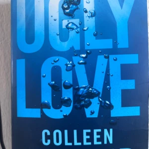 Ugly Love - En bok med blått omslag och vattenstänk, perfekt för dig som gillar starka känslor och relationer. Titeln och designen lockar till läsning om kärlekens utmaningar. Passar unga vuxna som vill ha en gripande och modern berättelse.