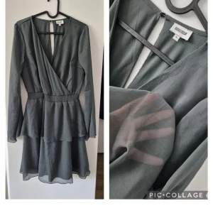 Grå omlottklänning från BubbleRoom - Supersnygg grå kortklänning från BubbleRoom med omlott-v-ringning, markerad midja med smock och volangdetaljer. Långärmad och i ett tunt, lätt och transparent polyestertyg som ger en luftig känsla. Perfekt för dig som gillar stilrena och trendiga plagg.