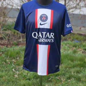 PSG Neymar Jr #10 matchtröja Nike M  - Paris Saint-Germain fotbollströja med Neymar Jr och nummer 10 på ryggen. Tröjan är marinblå med vit och röd vertikal rand, PSG-emblem och Qatar Airways-tryck. Tillverkad i Dri-FIT-material som andas. Kortärmad och perfekt för fotbollsfans.