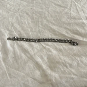 Kedjearmband i silver - Stilrent kedjearmband i silverfärg med klassisk länkkedja och karbinlås. Perfekt accessoar för en cool och enkel look. Passar både tjejer och killar som gillar minimalistiska smycken.