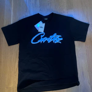 Corteiz T-shirt svart och blå - Svart t-shirt från Corteiz  oanvändbar och i topp skick.Även fast den är i storlek M så kan den passa S.Förexempelvis jag har en likadan och är 175 och den passar mig fast den är lite lös så folk i S kan också ha på sig den om man gillar en lösare utseende. OBS OM DU HAR FRÅGOR OM PRISET ELLER VART JAG KÖPTE DEN IFRÅN VA INTE RÄDD ATT FRÅGA 🙋‍♂️👍🏽kommer frakta så fort som möjligt nu när de är lov 