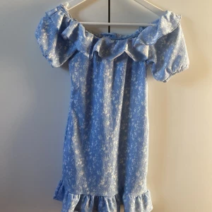  offshoulder klänning Gina Tricot - Supersöt blå kort klänning från Gina Tricot, offshoulder-modell och volangdetaljer vid halsringning och fåll. Köpt till skolavslutning men använde den aldrig och nu har jag växt ur den. Den är på gränsen till för kort för mig som är 165💓kontakta mig vid köp