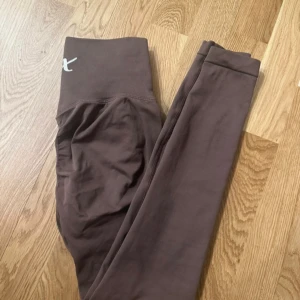 X shapes seamless scrunch  leggings - Snygga bruna seamless leggings med hög midja och diskret logga framtill samt scrunch söm i bak som framhäver ben och rumpa på ett smickrande sätt. Säljer då jag har för mycket träningskläder, de är endast använda 2-3 gånger så i fint skick 🩷