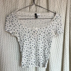 Vit blommig topp från Divided🤍 - Söt vit ribbad topp från Divided med små blommor i blått och grönt.  🪻