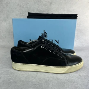 Lanvin DBB1 cap toe sneaker - – Condition: 7,5/10  - Size: 45/UK11  – What is included: Dustbag  – Retail price: 6000 + SEK  Please note that Lanvins fit big and our recommendation is to go one size down