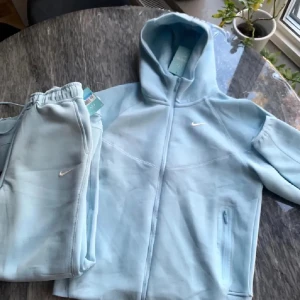 Nike Nocta Tracksuit  - Säljer en ljusblå Nocta Tracksuit, fick den i present men passar inte mig därför säljer jag den! Den är helt ny och oanvänd, den kommer med tags, inplastad och med kvitto! Perfekt vår våren och sommaren så passa på🌞