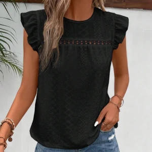 Svart blus med volangärm och spetsdetalj - Svart blus med korta volangärmar och dekorativ spetsdetalj över bröstet. Blusen har ett diskret hålmönster i tyget och rund halsringning. Perfekt att styla med jeans eller kjol.