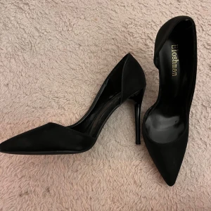 Svarta pumps från Eloshman med klack - Stilrena svarta pumps från Eloshman med spetsig tå och hög klack. 