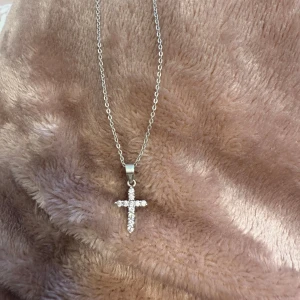 Äkta silver kors  - Äkta silver kors med små diamanter. Litet och snyggt. Ungefär 40cm lång 