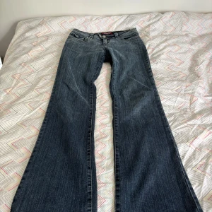 Snygga lowrise bootcut vintage jeans  - Snygga blå jeans från Dockhouse med bootcut passform och slitna detaljer på bakfickorna. Köpta i Köpenhamn och säljer nu då de tyvärr är små på mig. Mycket bra skick 