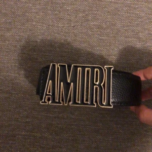 Svart skärp från Amiri med metallspänne - Säljer ett svart bälte från Amiri i äkta skinn med ett stort, stilrent metallspänne där det står AMIRI. Bältet har en klassisk design med präglad yta och bred passform. Perfekt för att lyfta din outfit med en lyxig touch.