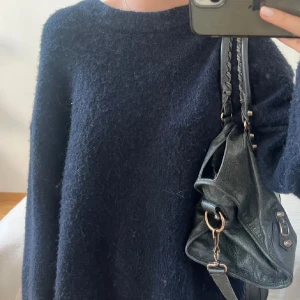 Mörkblå stickad tröja från Zara - Mysig mörkblå stickad tröja från Zara med rund halsringning och lång ärm. Tröjan har en enkel och clean look, perfekt att slänga på sig när det är kyligt ute. Passformen är normal och materialet känns mjukt och fluffigt.