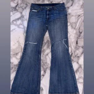 Snygga jeans från Levis  - Säljer ett par jätte snygga jeans från Levis. Använda ett par gånger. Hål vid knänen och lite trådar längst ner på jeansen. Väldigt bra skick! 