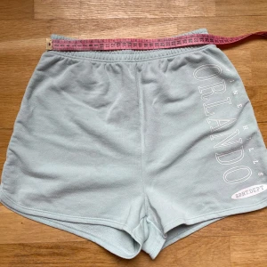 Ljusgröna shorts - Snygga ljusgröna shorts med tryck längs ena benet. De har elastisk midja och är tillverkade i mjuk bomull, perfekta för chill dagar eller sport. 
