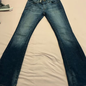 Blå bootcut jeans från Only - Blåa jeans med ”blekningsfläckar” på knäna 