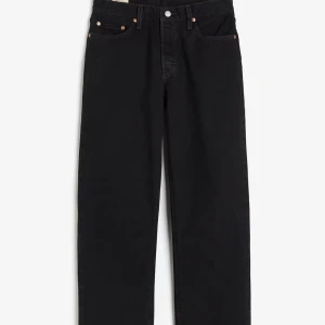 Svarta Levis 501 jeans straight fit (90s) - Klassiska svarta Levis 501 jeans med rak passform och fem fickor. Jeansen har knappgylf och är tillverkade i slitstark denim. Perfekta för dig som gillar en tidlös och clean look.