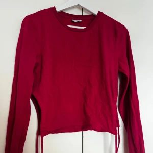 Rosa croppad långärmad tröja - Säljer en enkel och stilren  rosa croppad tröja med långa ärmar. Perfekt att matcha med höga jeans eller kjol. Tröjan har en rund halsringning och är i mjukt material.