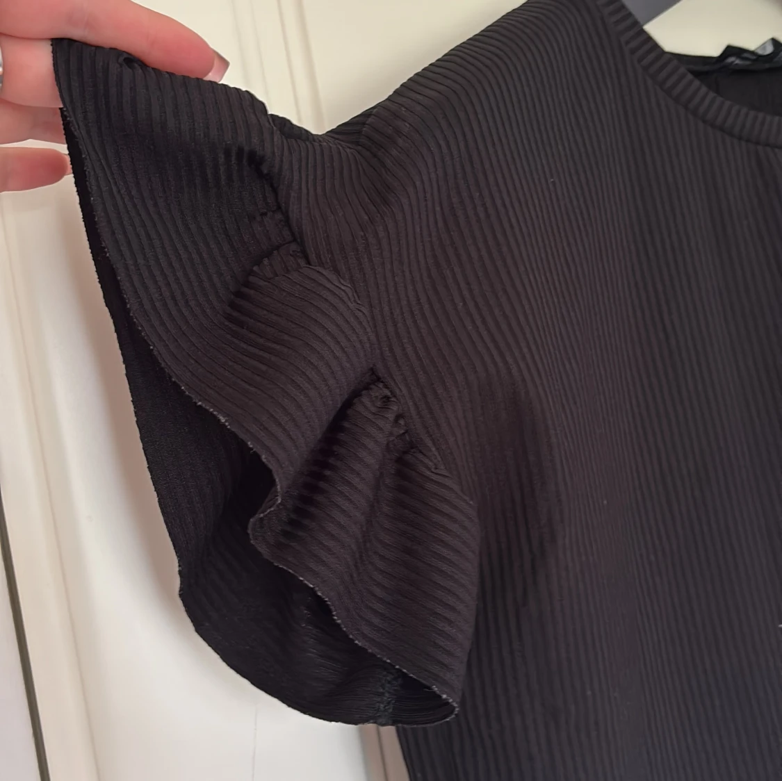 Svart ribbad topp med volangärmar - 2