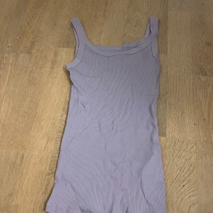 Ljuslila ribbad linnetopp Intimissimi - Supersöt ljuslila ribbad linnetopp från Intimissimi i 100% Supima bomull. Topp med breda axelband och figurnära passform, perfekt att styla med jeans eller kjol. 