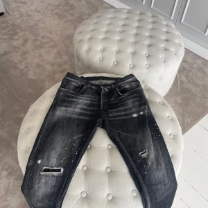 Svarta Dondup jeans med slitningar - Snygga svarta dondup jeans med coola slitningar och en tvättad look. De har en klassisk femficksdesign och en modern stil. Perfekta för en avslappnad och trendig stil. Nypris ca 2000-2500