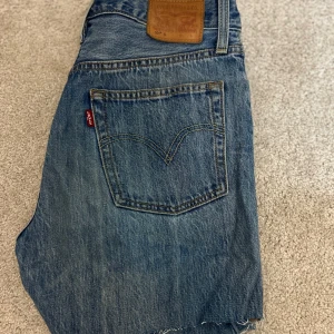Blå jeansshorts från Levi's - Säljer ett par klassiska blå jeansshorts från Levi's med en snygg fransig kant.