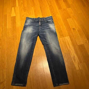 Blå jeans från Dsquared2 - Vet inte riktigt storleken men passar dom som e 160 ish!!!! Snygga blå jeans från Dsquared2 med en klassisk femficksdesign och lätt slitna detaljer. De har en knappgylf och en läderpatch med logotyp baktill. Perfekta för en avslappnad stil. Använda ett fåtal gånger. 