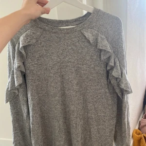Grå tröja med volang - Super söt tröja perfekt till skolan! Passar också storlek S.
