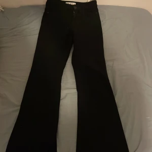 Svarta flare jeans från Stay - Snygga svarta flare jeans från Stay i storlek XS. Byxorna har en klassisk design med hög midja och en utsvängd flare-stil. Perfekta för en stilren look.