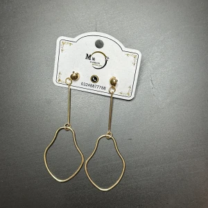 Guldörhängen från MM Fashion - Eleganta guldörhängen med unik, abstrakt form. De har en lång, smal design som ger en modern och stilren look. Perfekta för att ge en touch av glamour till din outfit.